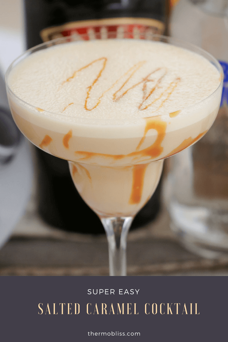 A creamy cocktail with swirls of caramel in a long stemmed cocktail glass 
