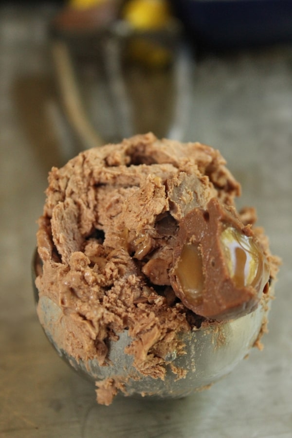 A big scoop of ice-cream with caramel gooey eggs inside. 