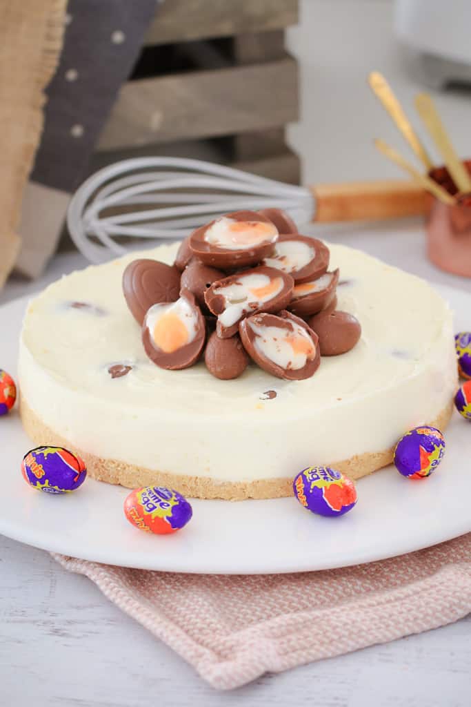 Cadbury Creme Eggs cut in half and placed on top of a white chocolate cheesecake. 
