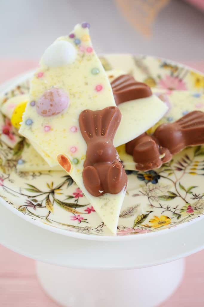 Malteser bunnies with colourful easter eggs on white chocolate. 