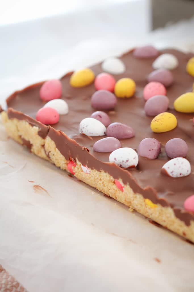An easter tray bake with chocolate and easter eggs. 