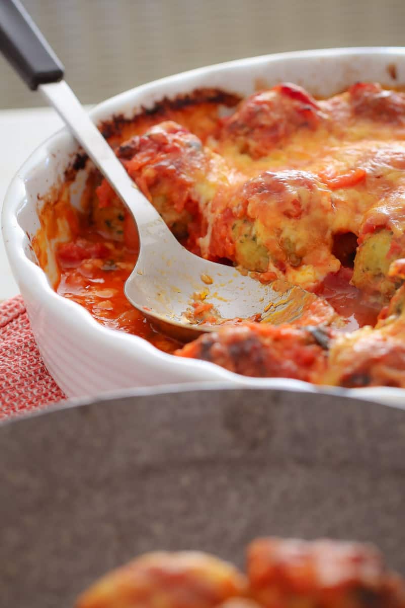 A family dinner baking dish of chicken, tomato and cheese meatballs. 