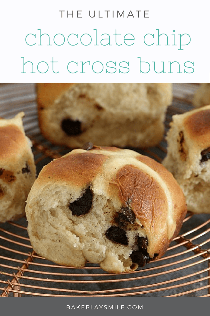 Four Hot Cross Buns made with chocolate chips on a copper wire tray