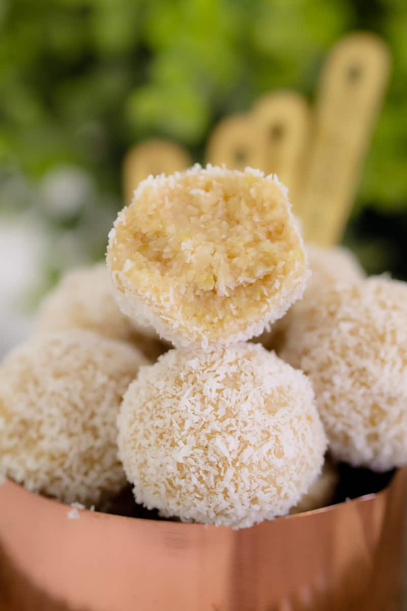 A bite of a lemon, cashew and coconut bliss ball. 