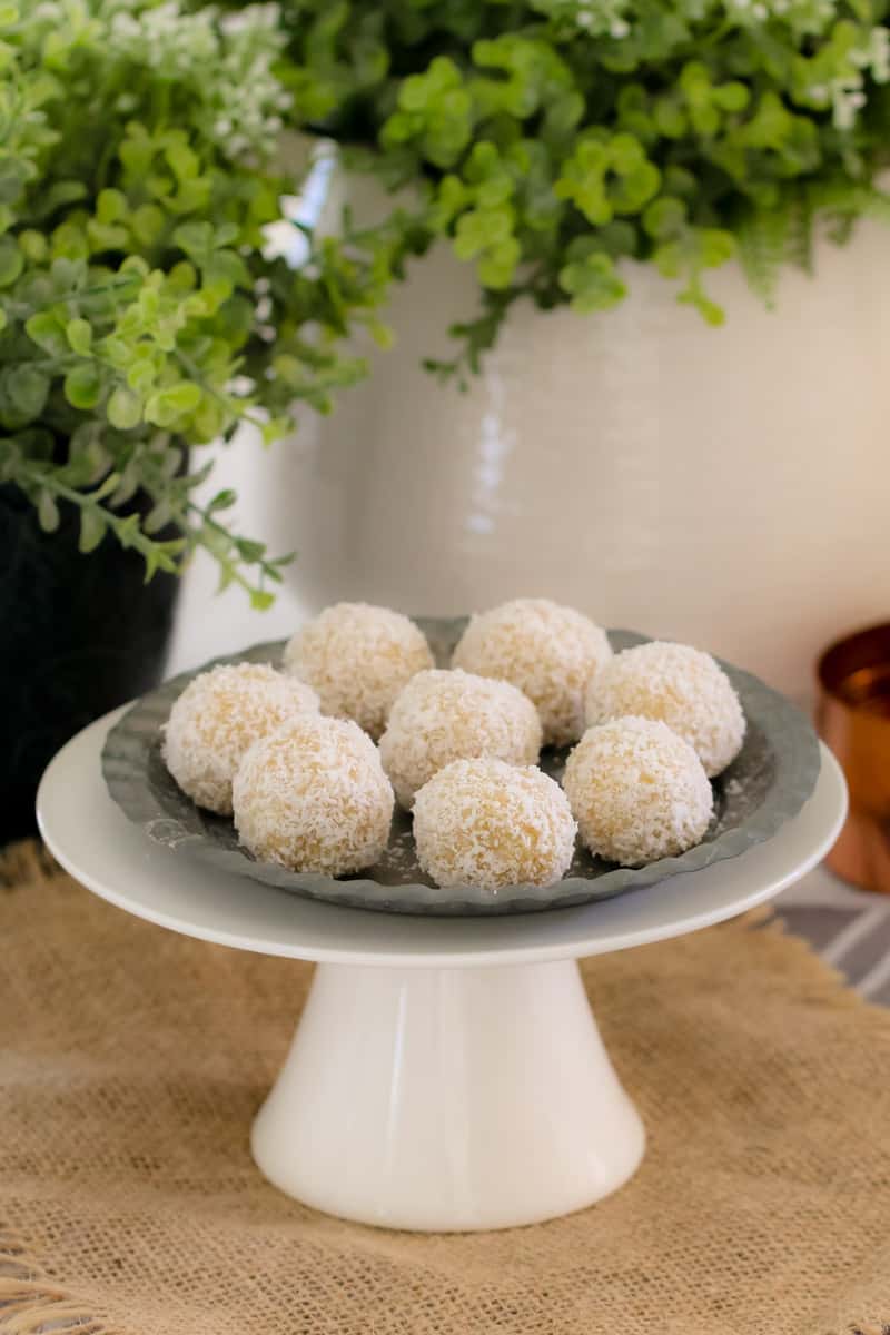 A plate of healthy lemon and coconut balls. 