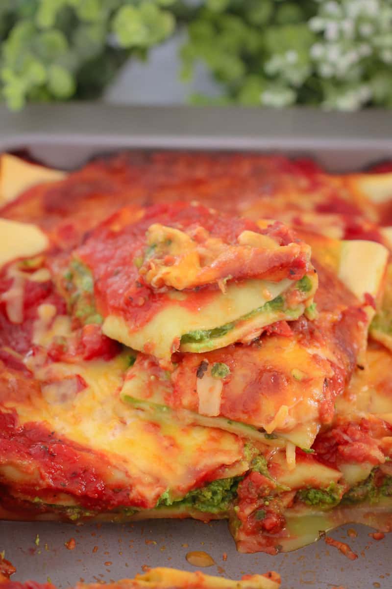 A close up of cannelloni showing layers of spinach, tomato and cheese
