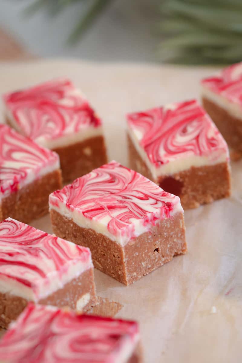 Squares of slice with a white and pink swirled chocolate topping