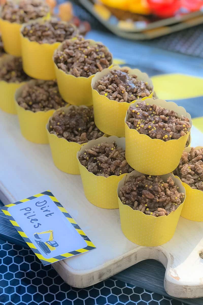 A row of stacked chocolate crackles cups to resemble dirt piles for a Digger Party