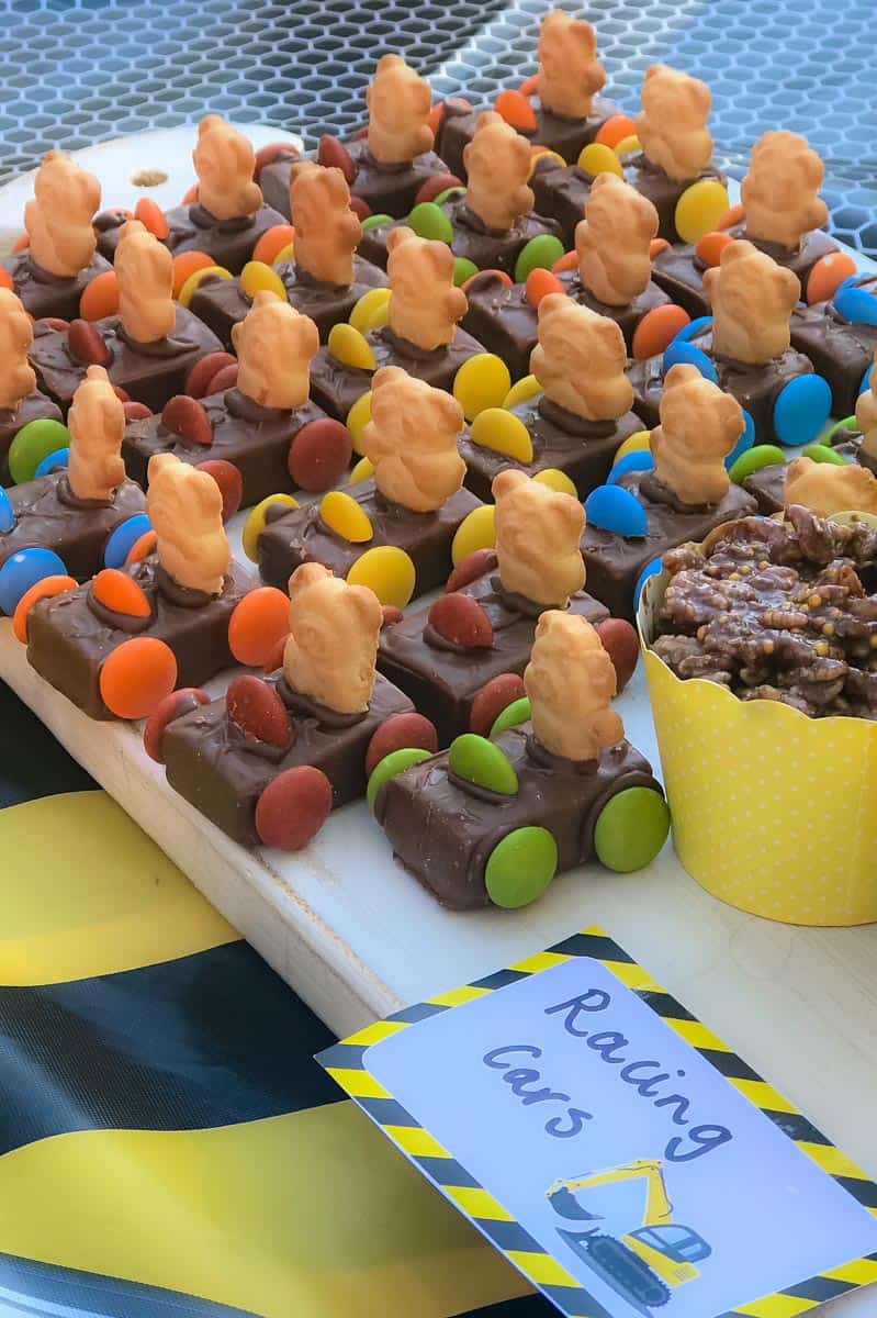 A group of mini chocolate bars decorated with smarties and tiny teddy biscuits to resemble Teddy Cars