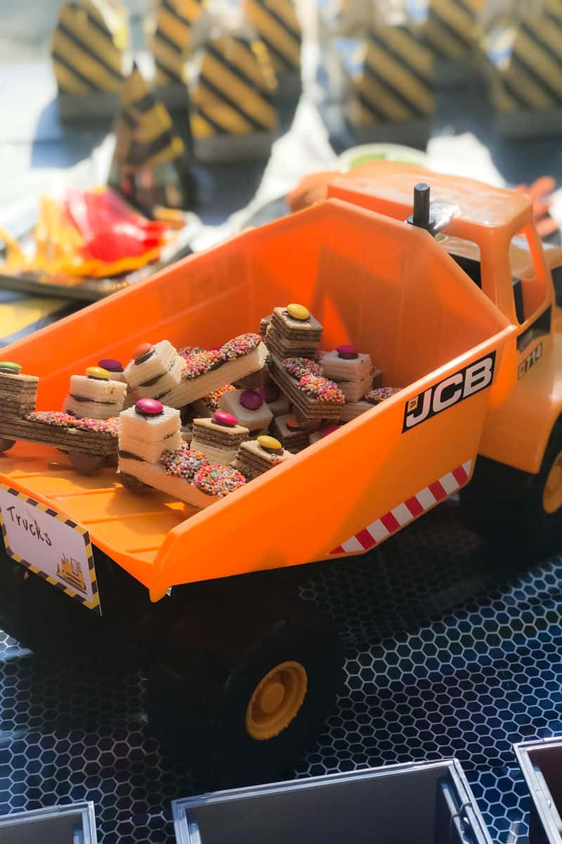 A plastic tip-truck filled with lolly decorated biscuits in the tip-tray