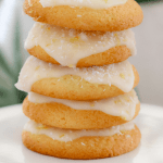 Five lemon coconut biscuits on top of each other on white plate
