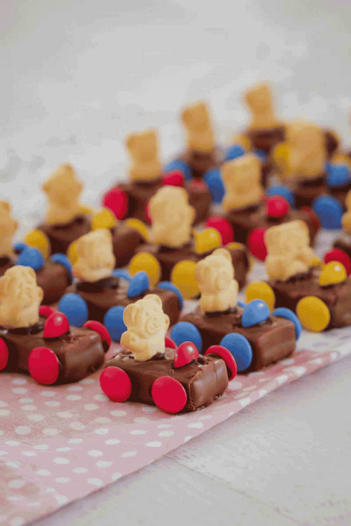Lines of racing cars made with Milky Way chocolate and tiny teddies.