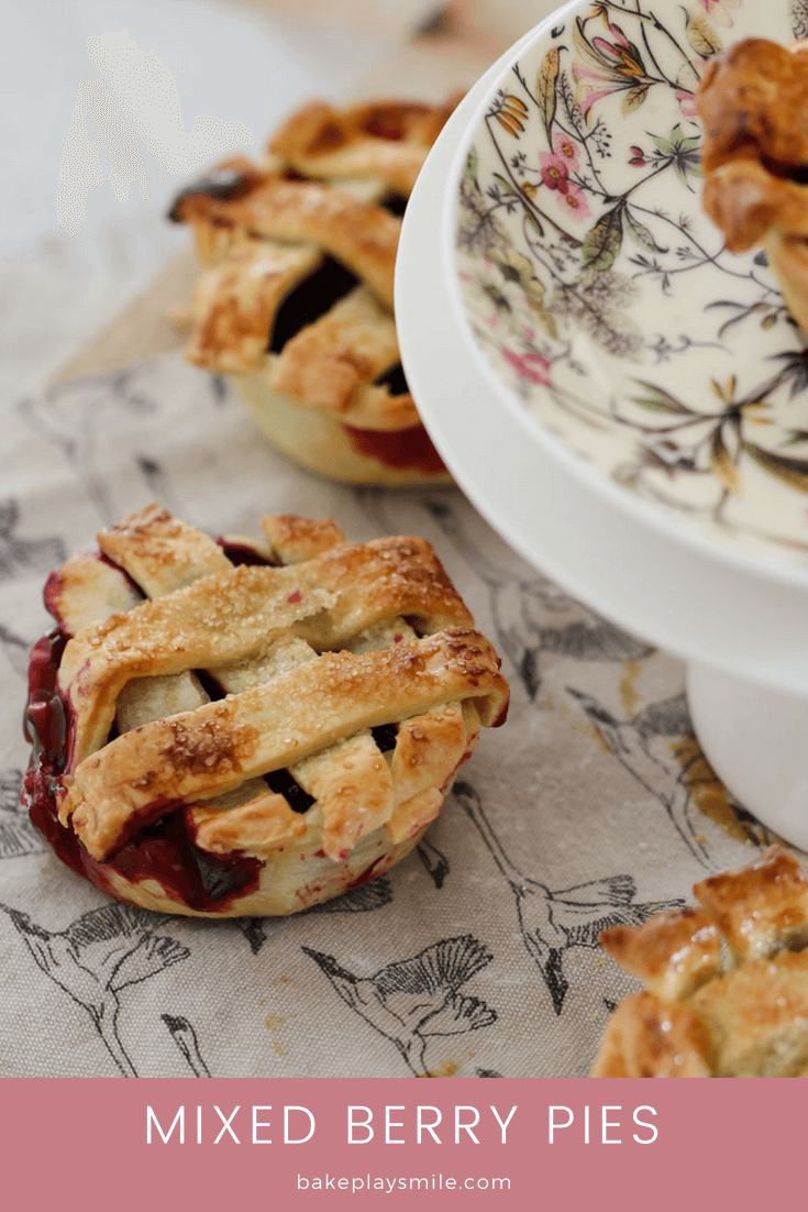 Mini pies filled with mixed berries and topped with pastry strips