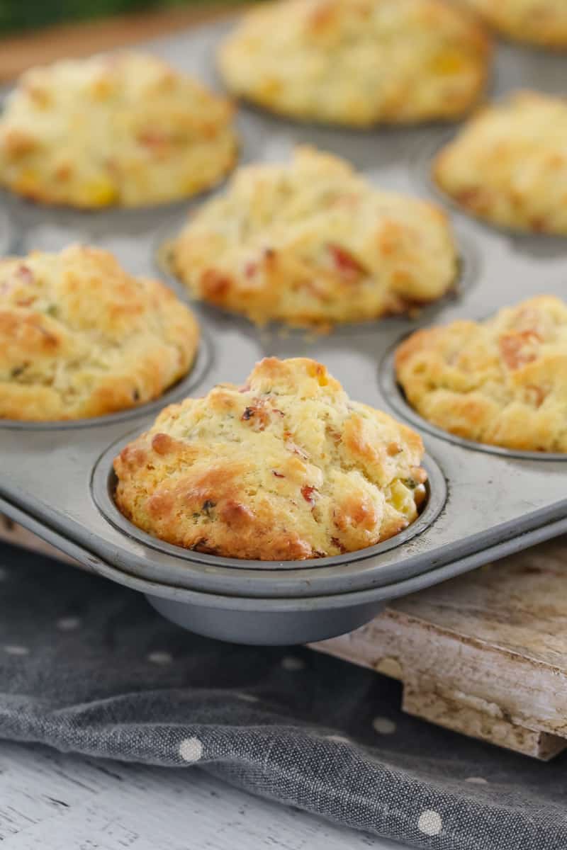 A muffin baking tray filled with savoury muffins
