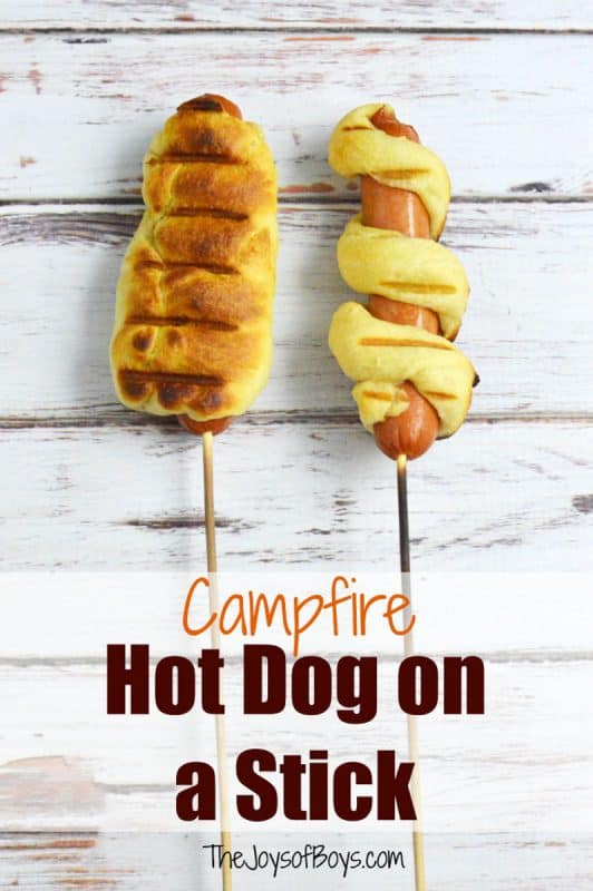 A hot dog wrapped in pastry on a stick. 