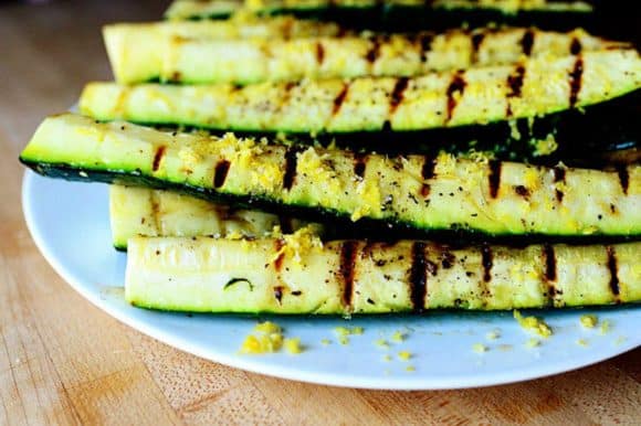 A plate of grilled zucchini with lemon salt.