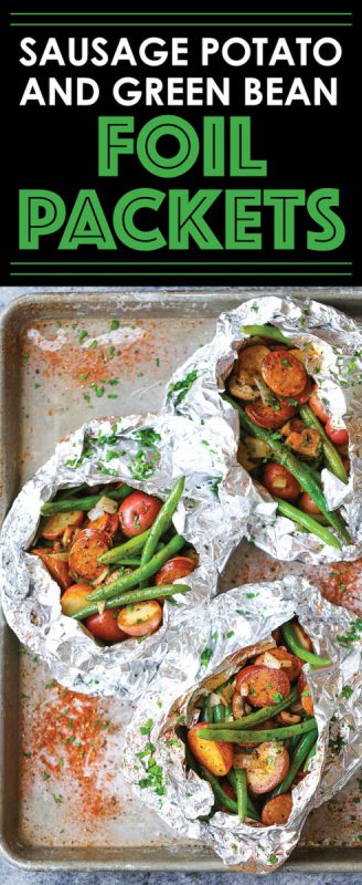 Foil packets filled with sausages, potatoes and beans. 