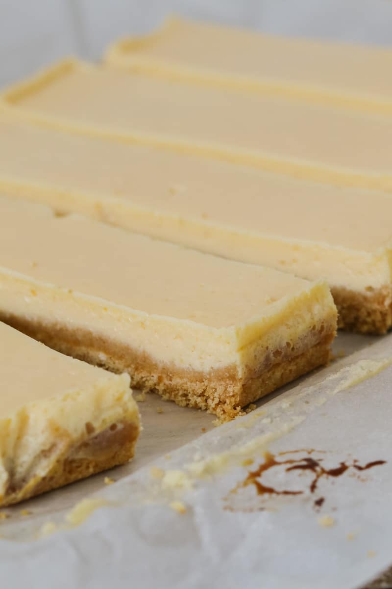 Lemon bars made with sweetened condensed milk and a biscuit base, cut into long slices