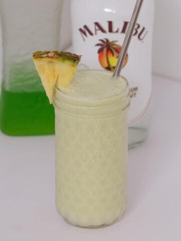 A creamy Midori Cocktail made with Midori liqueur, Bacardi rum, pineapple juice, lime juice, coconut cream and ice... the perfect summer drink!