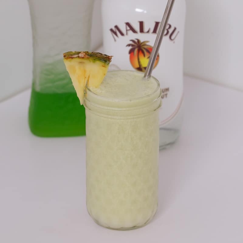 A creamy Midori Cocktail made with Midori liqueur, Bacardi rum, pineapple juice, lime juice, coconut cream and ice... the perfect summer drink!