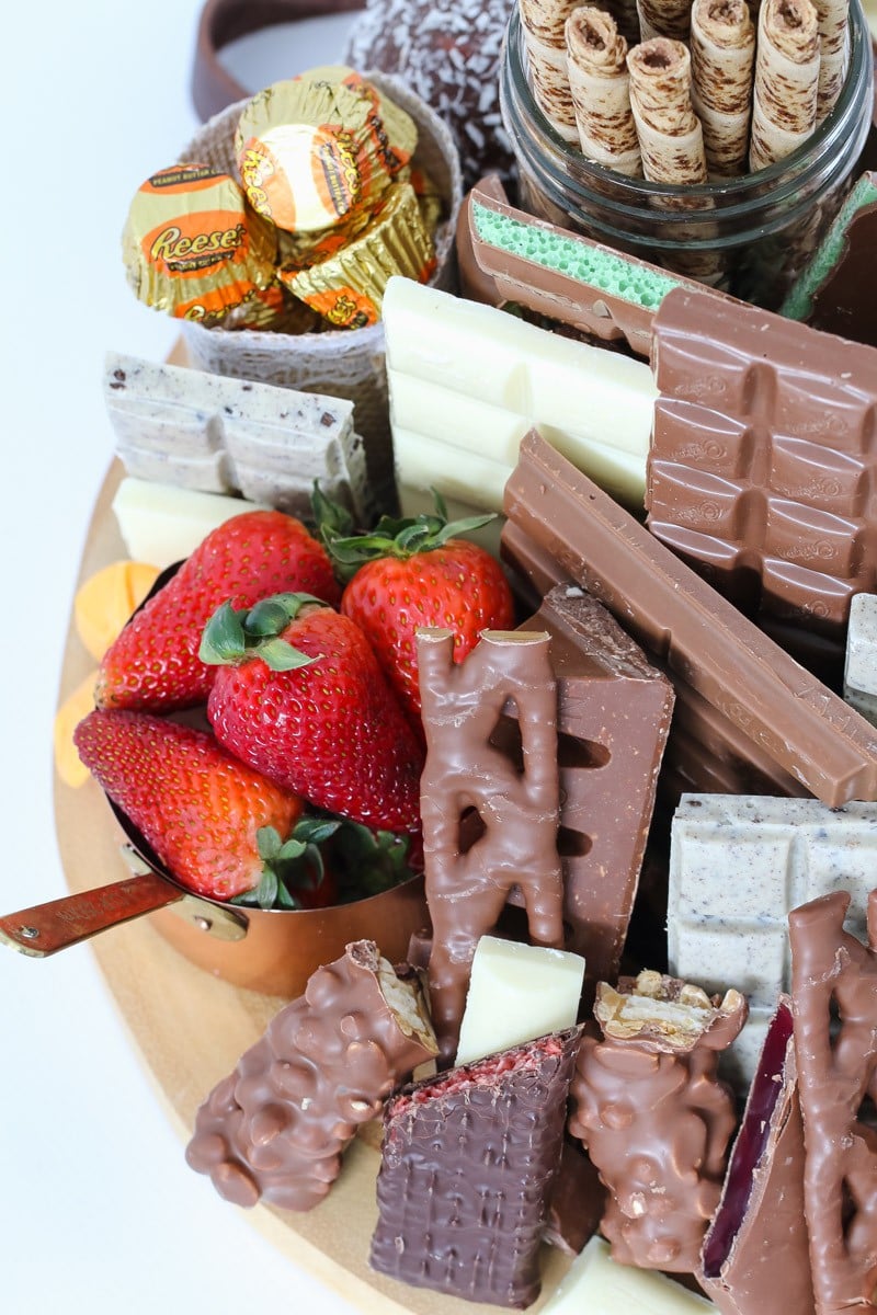 A selection of chocolate bars, sweets and fresh strawberries