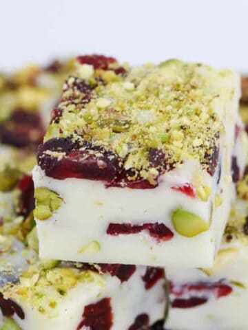 A super simple 4 ingredient microwave Christmas fudge recipe made from white chocolate, condensed milk, cranberries and pistachios... ready in less than 5 minutes!!