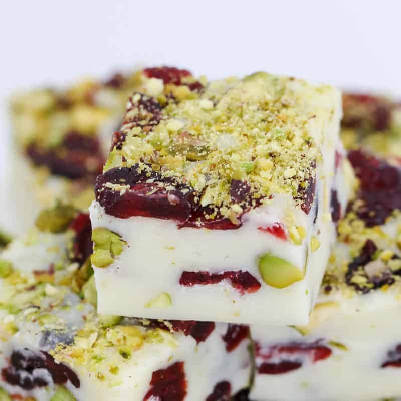 A super simple 4 ingredient microwave Christmas fudge recipe made from white chocolate, condensed milk, cranberries and pistachios... ready in less than 5 minutes!!