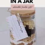 A jar with individual layers of ingredients to make cookies with.