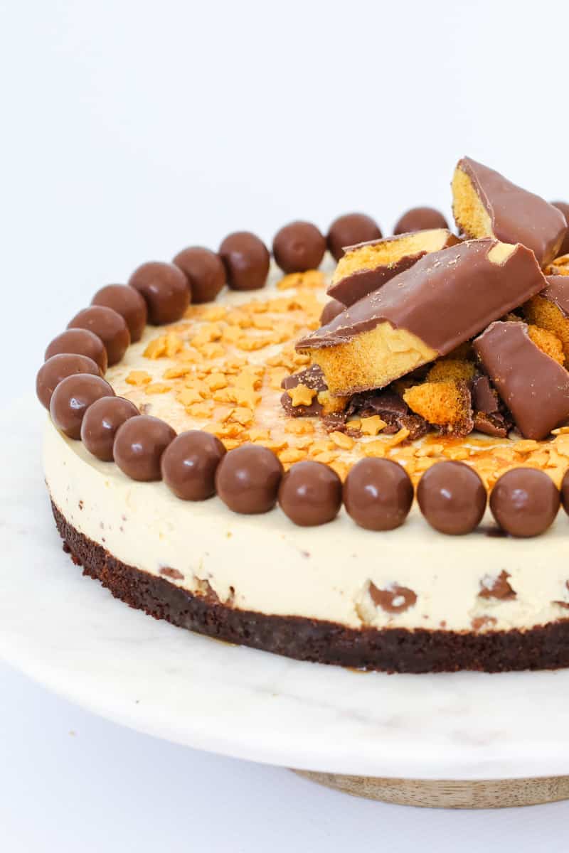 A chocolate based cheesecake filled and decorated with chocolate honeycomb and malted milk balls