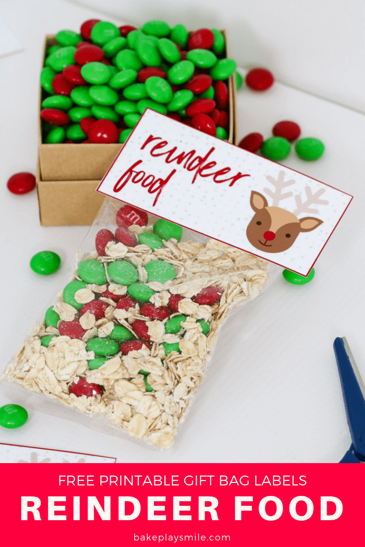 A clear plastic bag filled with rolled oats and red and green Christmas M&Ms with a Reindeer Food label. 