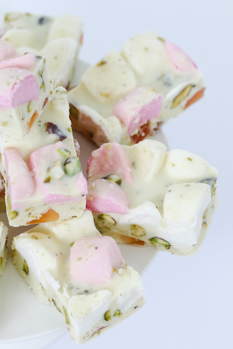 A plate of white Rocky Road pieces filled with chopped Turkish Delight, marshmallows and pistachios.