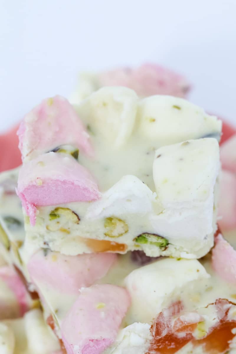 A close up of pieces of white Rocky Road showing marshmallows, turkish delight and pistachios inside