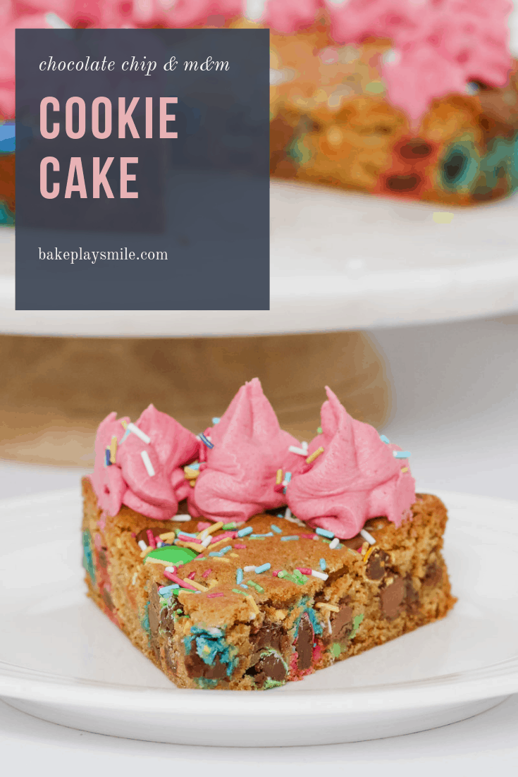 Slice of chocolate chip cookie cake with pink frosting and sprinkles on a white plate.