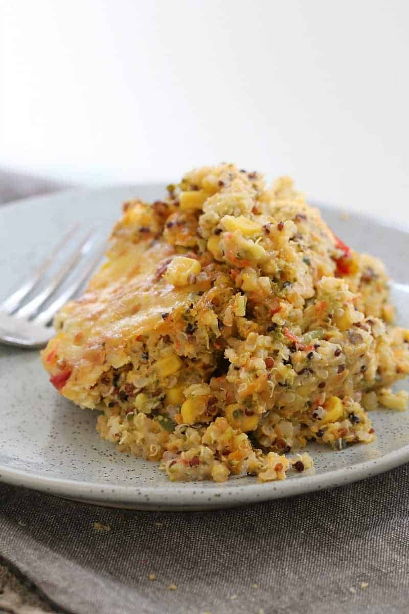 A plate of quinoa and vegetables that's been baked in a creamy sauce in the oven.