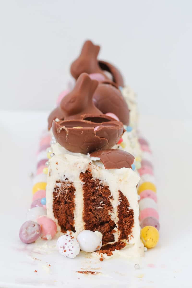 A slice of chocolate ripple cake decorated with Easter treats.