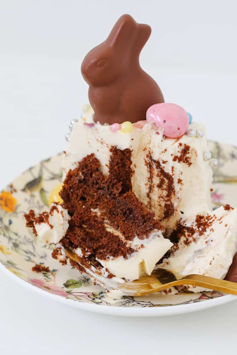 A close up of a serve of no-bake Easter chocolate ripple cake made with whipped cream and chocolate cookies. 