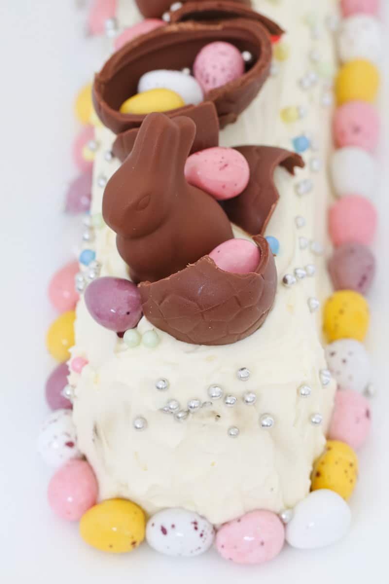 Easter eggs on top and around a chocolate ripple cake. 