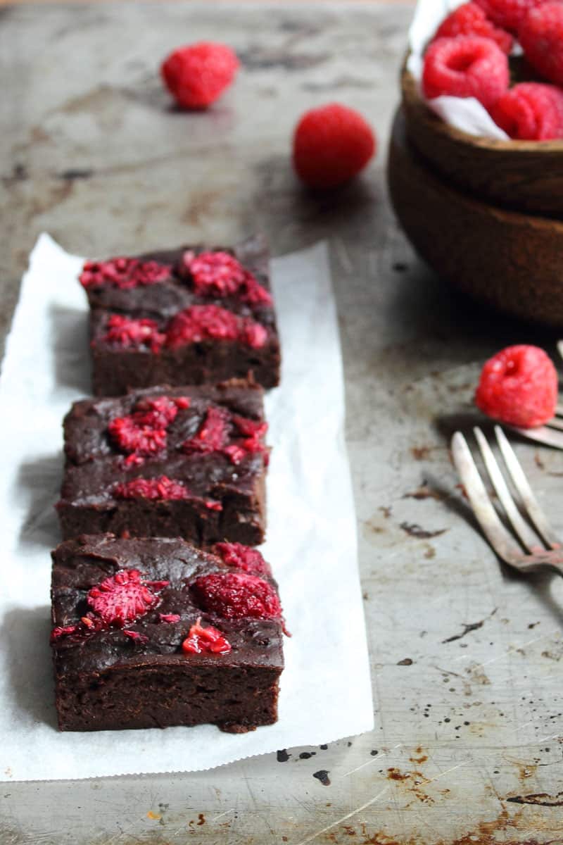 Three pieces of chocolate brownies with raspberries. 
