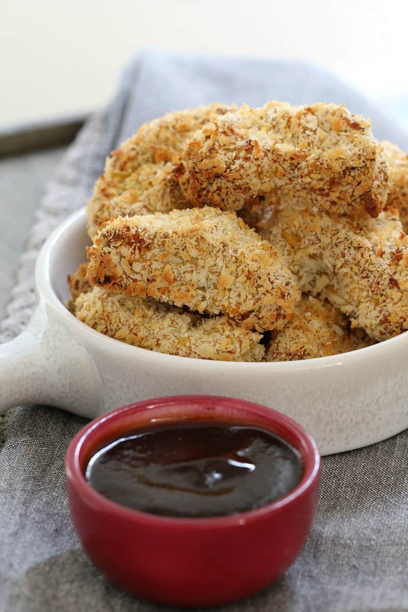 A bowl of chicken nuggets and sauce