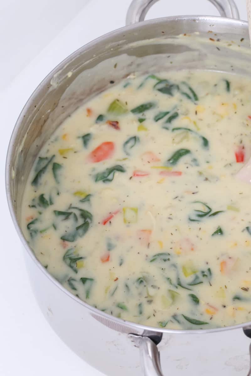 A pot of creamy chicken and vegetable soup. 