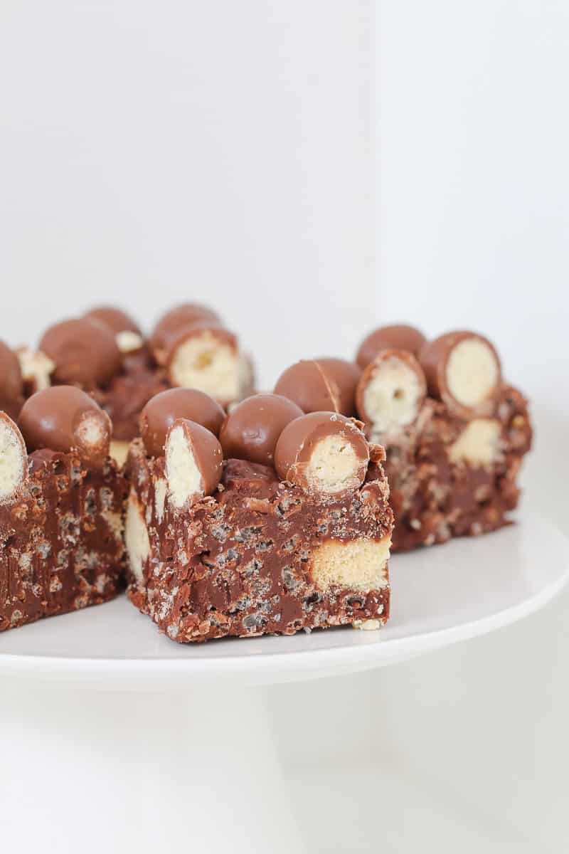 A piece of chocolate slice with chocolate crackles and Maltesers. 