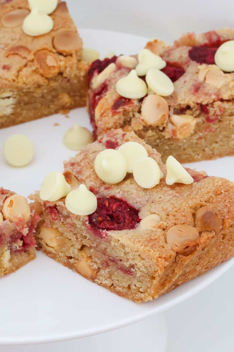 White chocolate chips and raspberries in a baked blondie. 