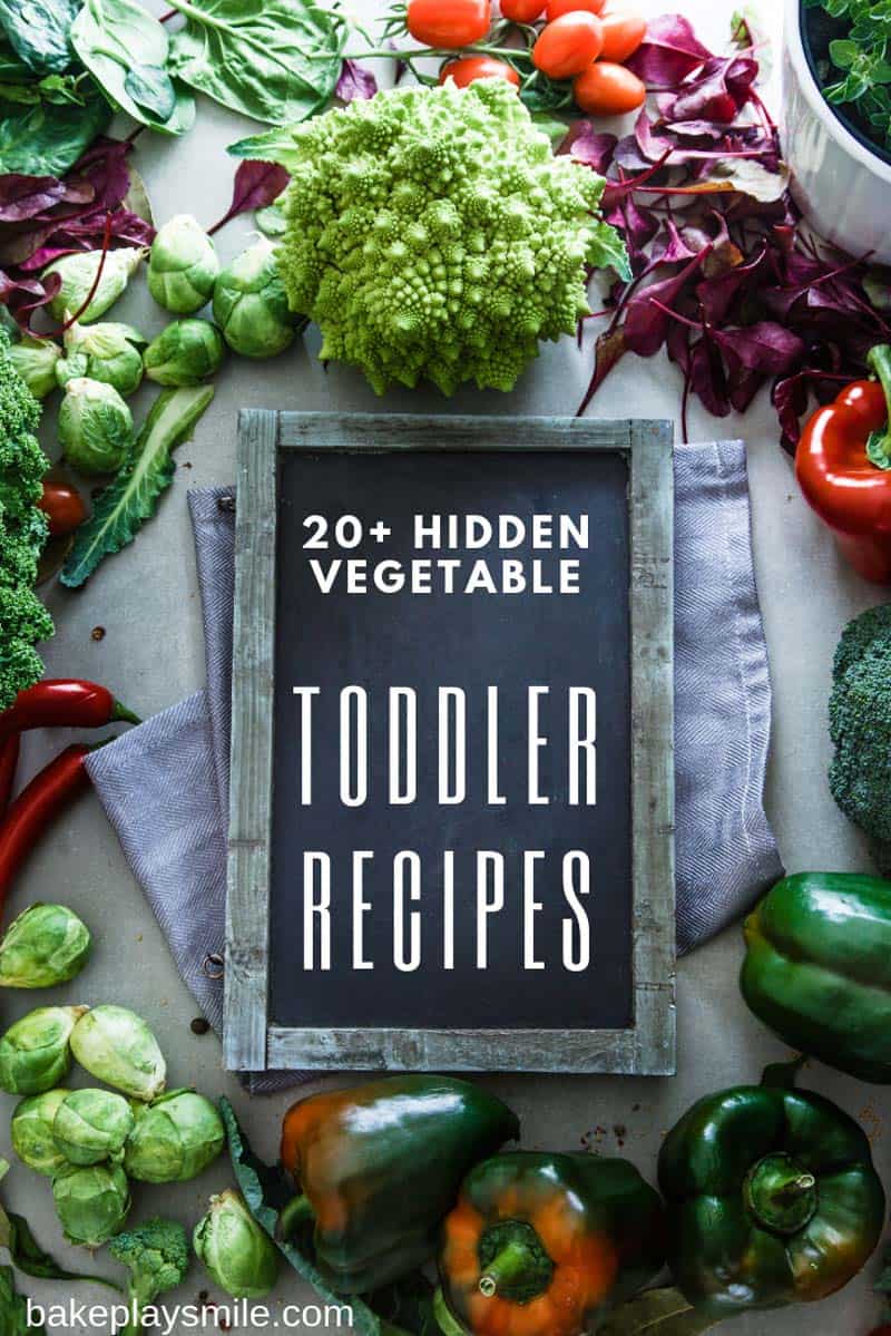 A sign for Toddler Recipes surrounded by colourful fresh vegetables.