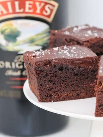 A rich and deliciously boozy chocolate Baileys Brownies recipe made with Irish cream liqueur and topped with a smooth chocolate frosting. 
