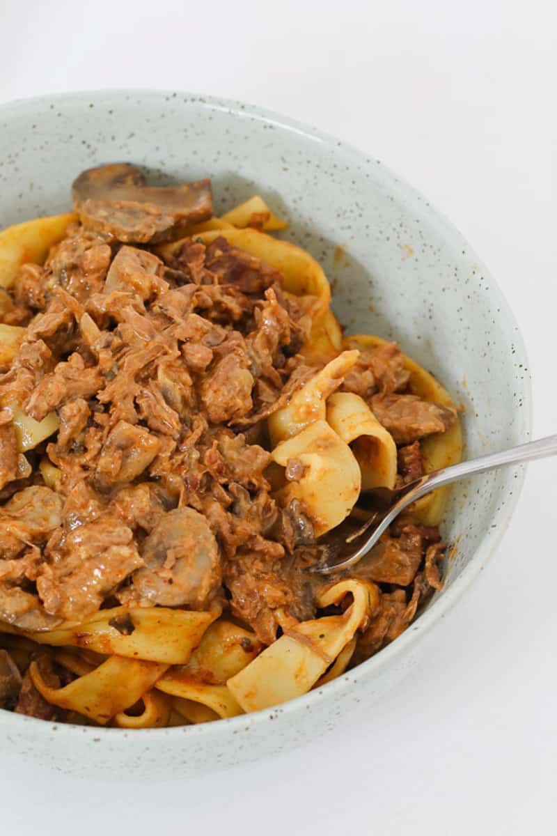 A close up of homemade slow cooker beef stroganoff with a creamy mushroom sauce.