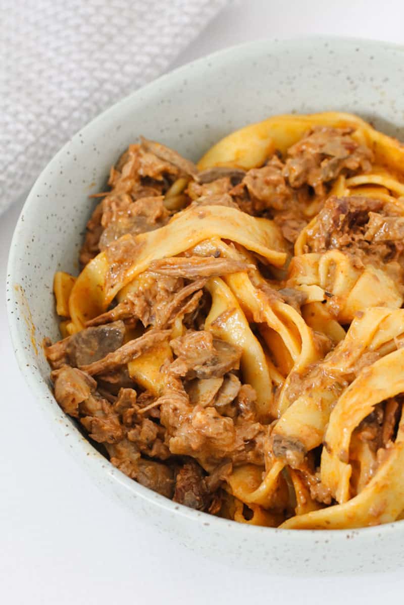 A winter slow cooker recipe of beef stroganoff with mushrooms and a creamy sauce.