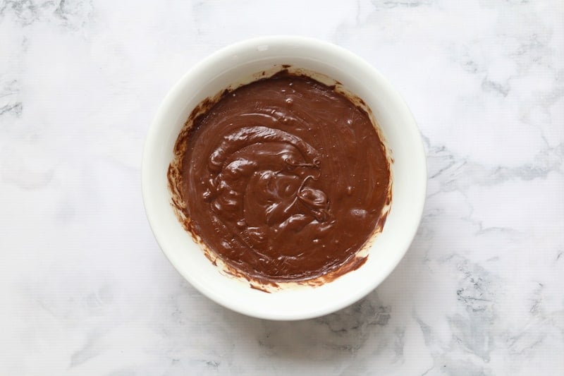 Melted chocolate and sweetened condensed milk in a bowl.