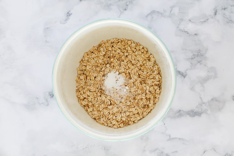 Oats in a mixing bowl with salt and bi-carbonate soda. 