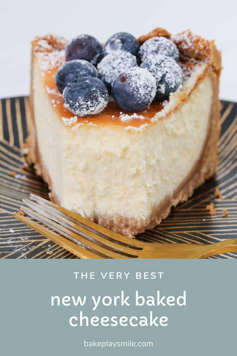 A slice of cheesecake on a plate decorated with blueberries. 