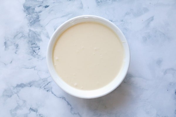 Creamy cheesecake filling in a white bowl. 